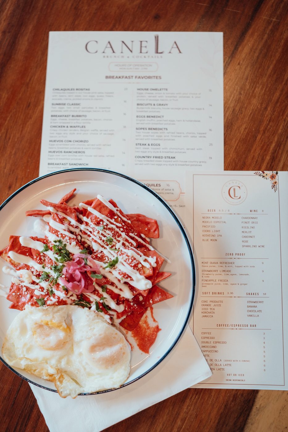 Chilaquiles Rositas topped with skirt steak, eggs, queso fresco, avocado, and crema