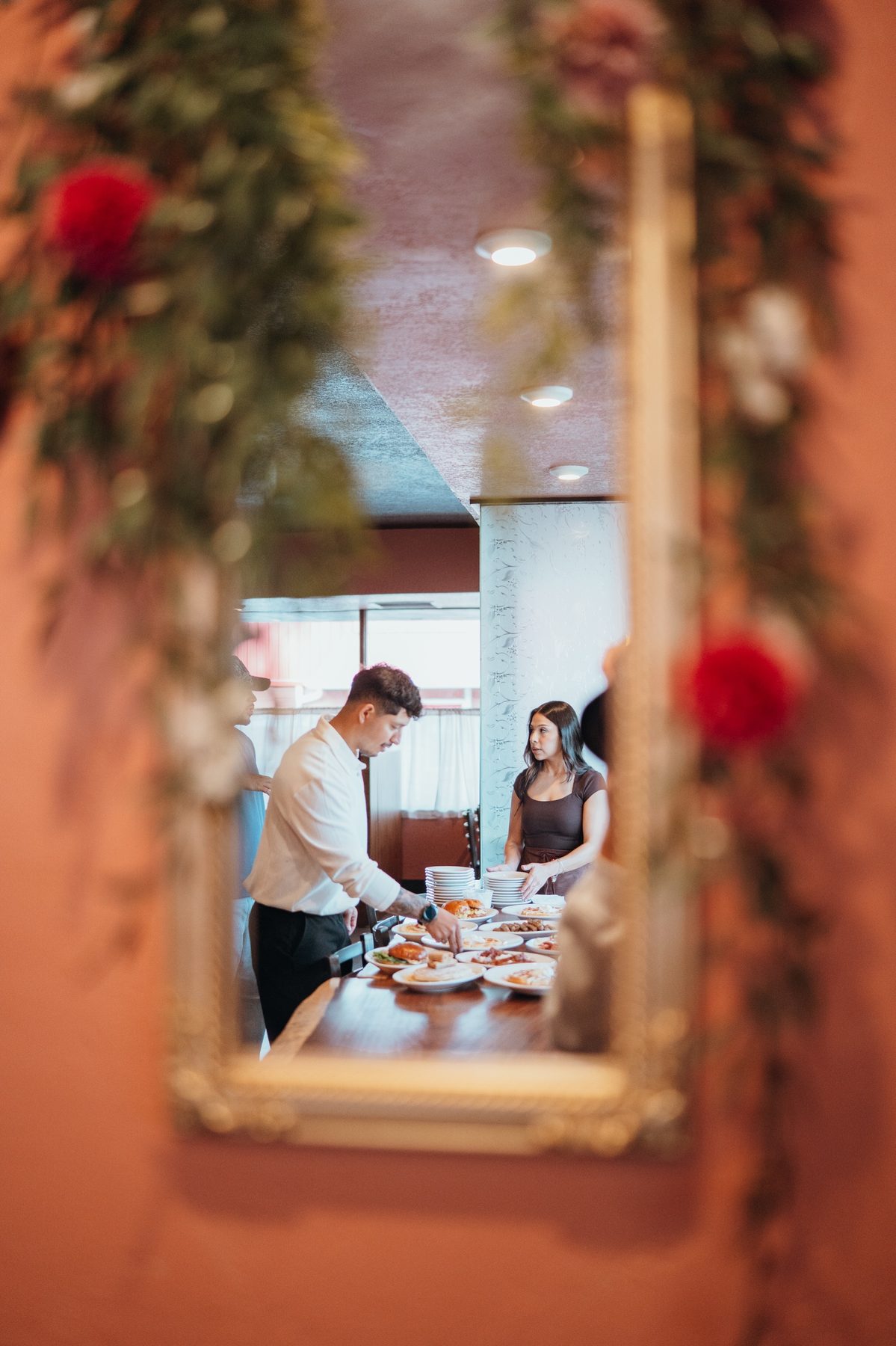 Canela staff plating dishes, reflected in a mirror